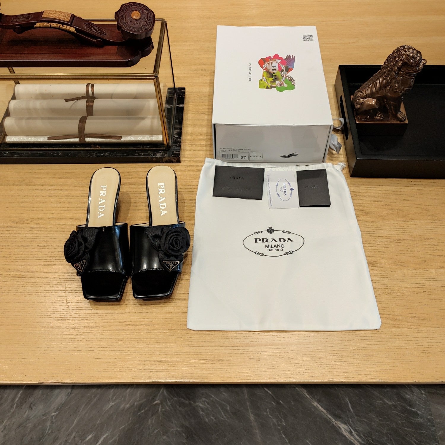 Prada 26s Open Toe Mules 45mm In Black Patent Calfskin With Rosette