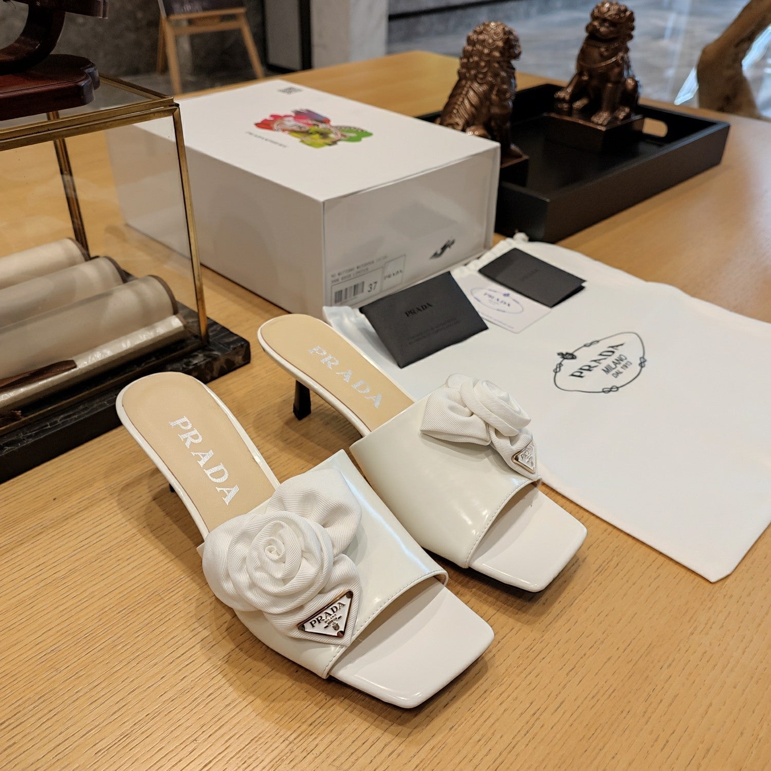 Prada 26s Open Toe Mules 45mm In White Patent Calfskin With Rosette