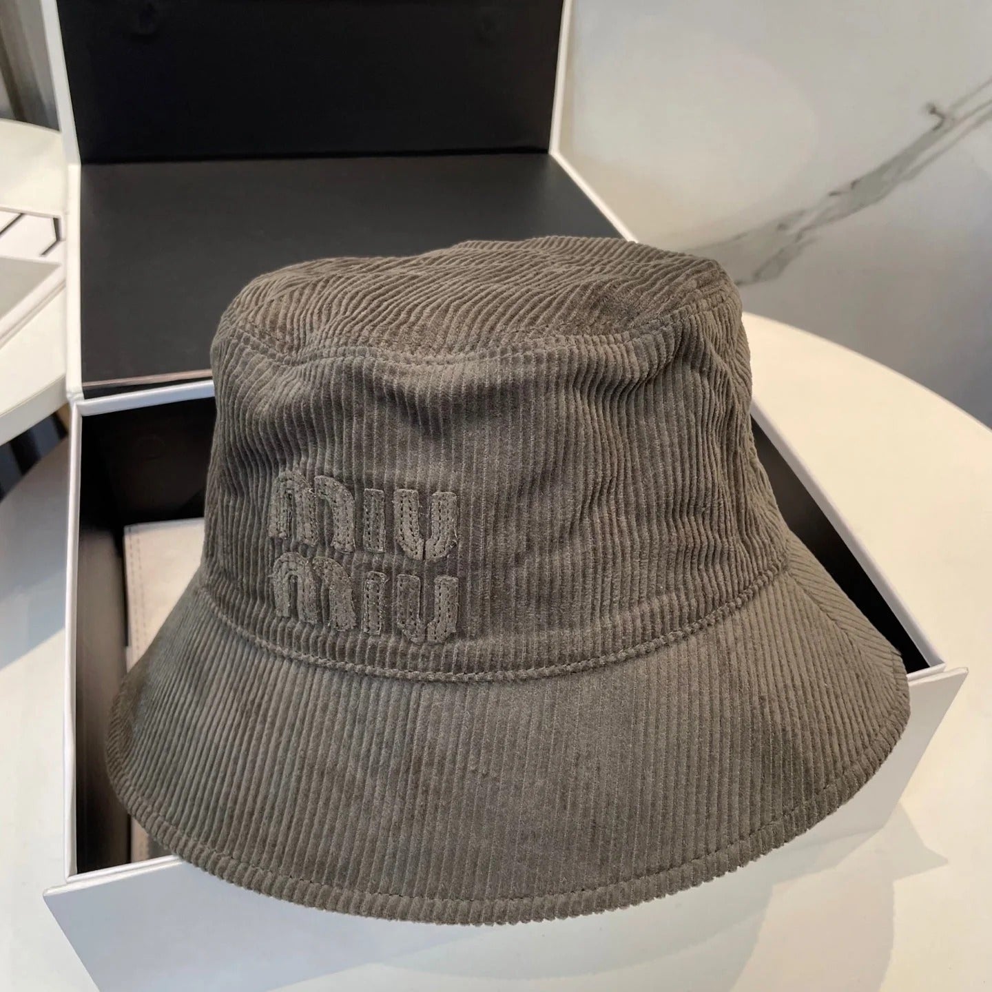 MM BUCKET IN MUTED BROWN VELVET WITH LOGO