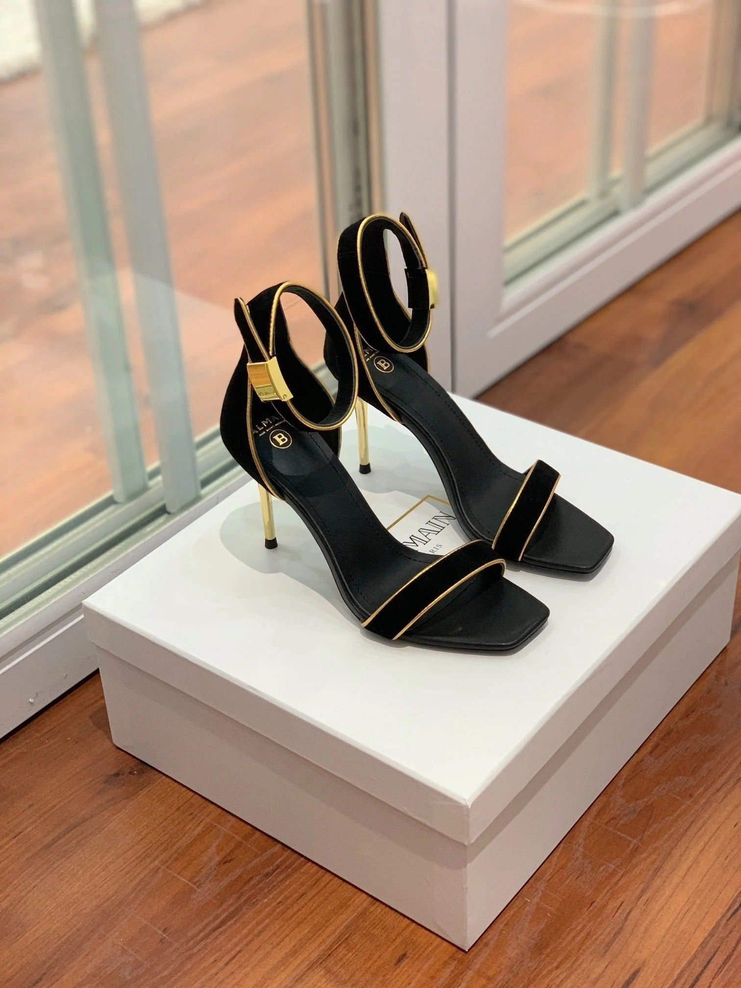 BALMAIN 25S UMA HEELED SANDALS 105MM IN BLACK SUEDE GOLD HARDWARE