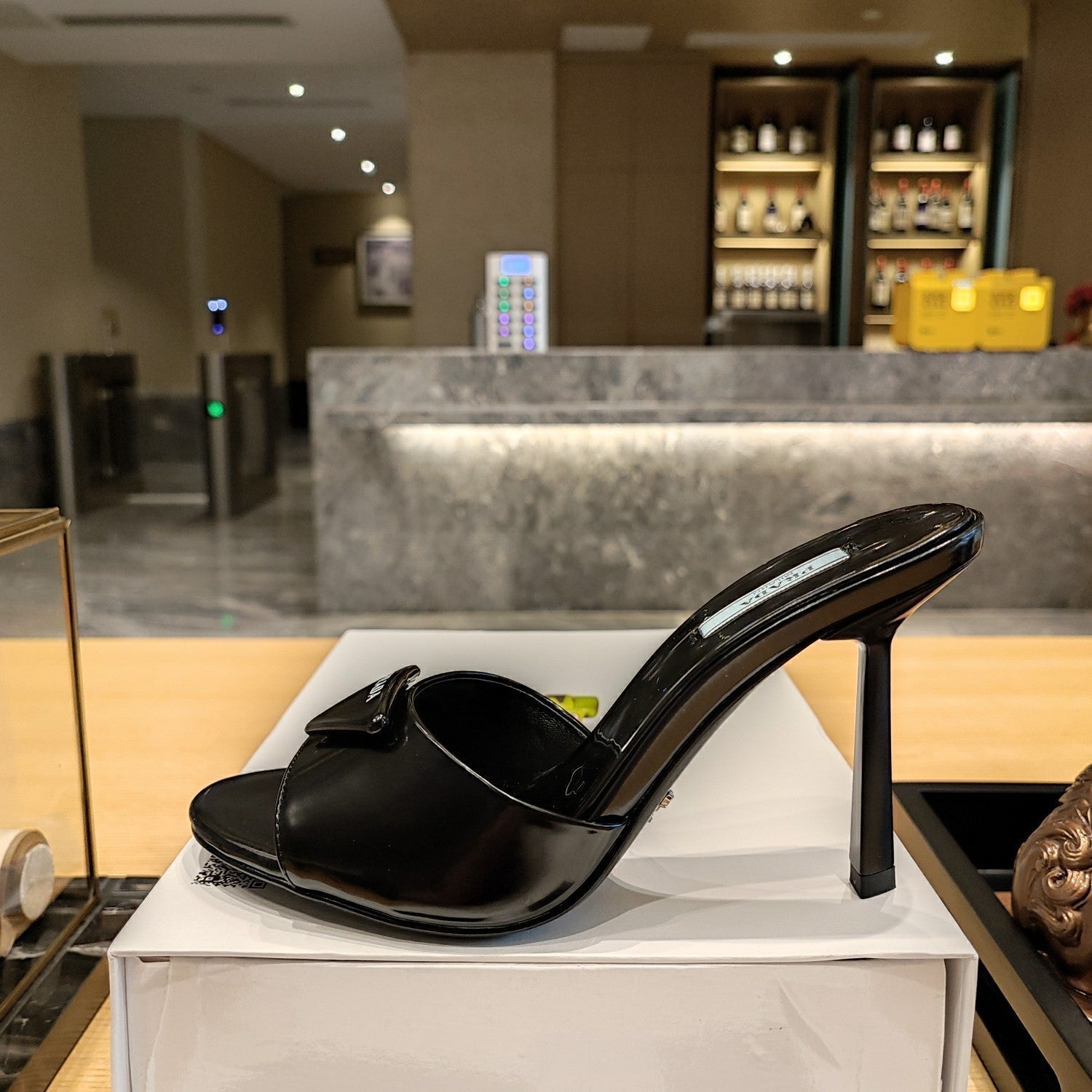 Prada 26S Open-Toe Mules 100mm in Black Patent Calfskin with Logo