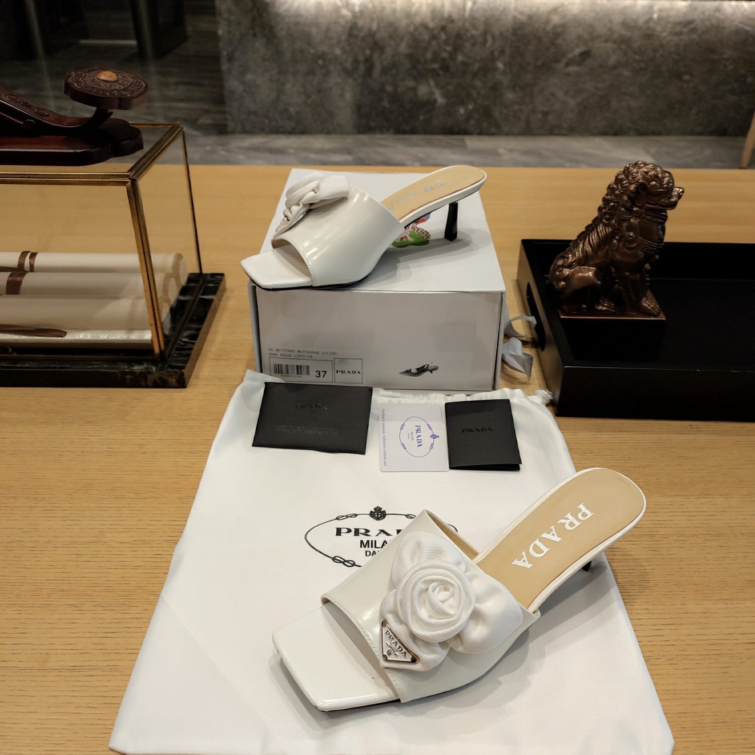 Prada 26s Open Toe Mules 45mm In White Patent Calfskin With Rosette